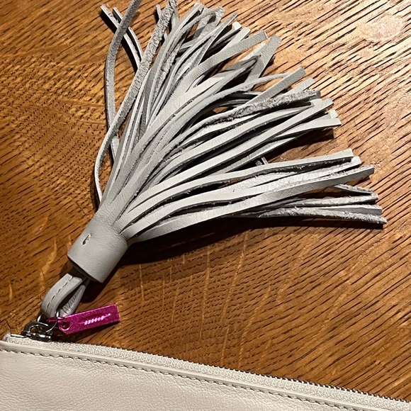 Stylish White Wristlet with Tassel Accent